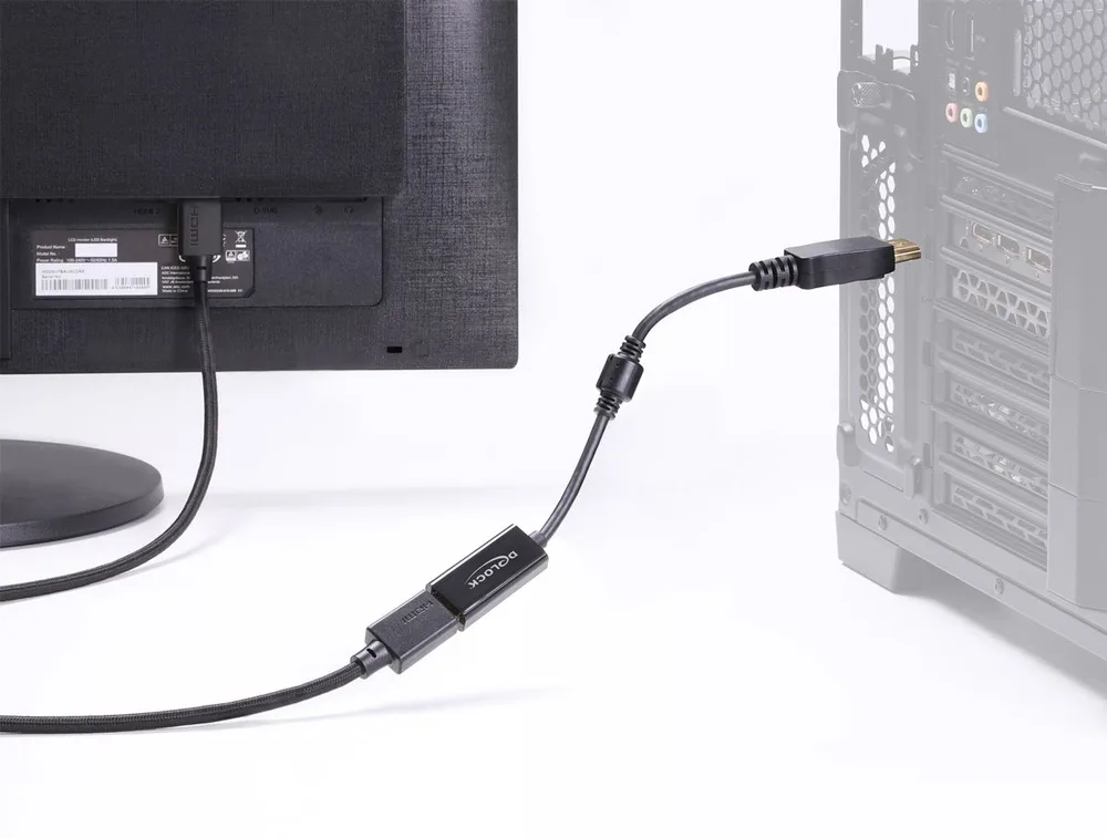 Αντάπτορας DisplayPort σε HDMI της DELOCK συνδεδεμένος ανάμεσα σε οθόνη και υπολογιστή, μαύρο καλώδιο με βύσματα σε λειτουργία